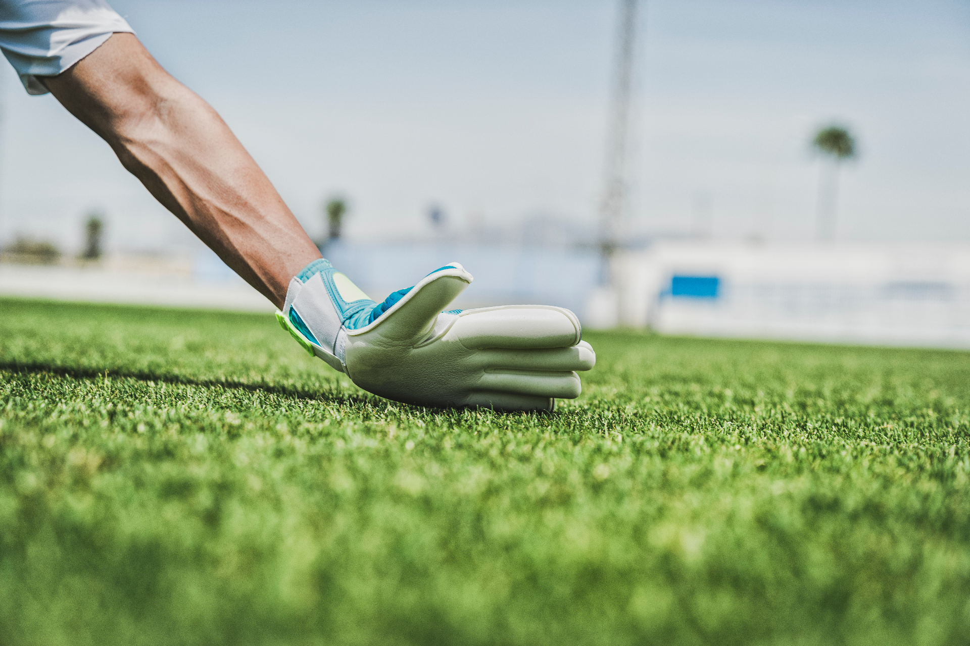 Goalkeeper glove reaching for the ball on the pitch